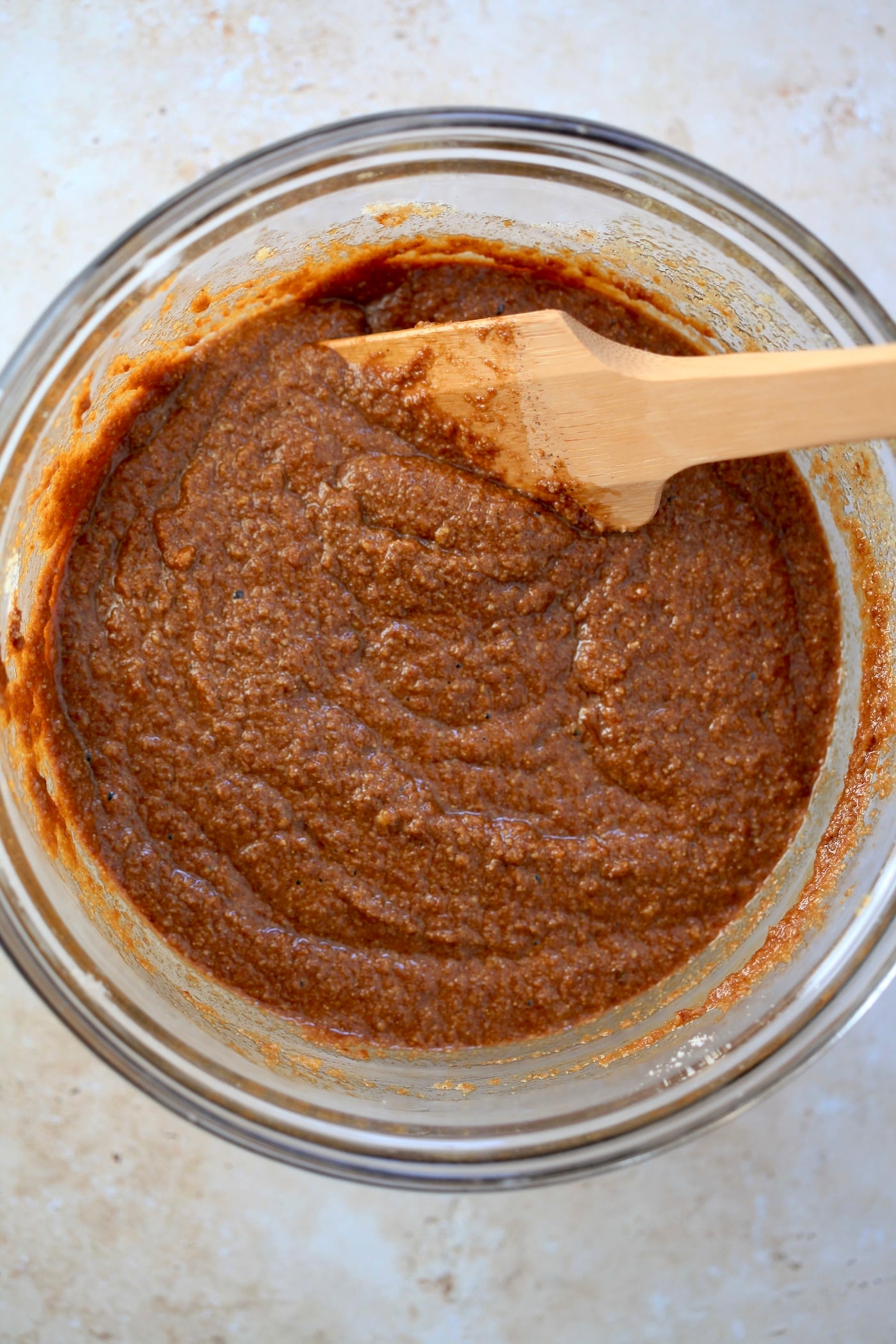 brown batter in bowl with wooden spoon.