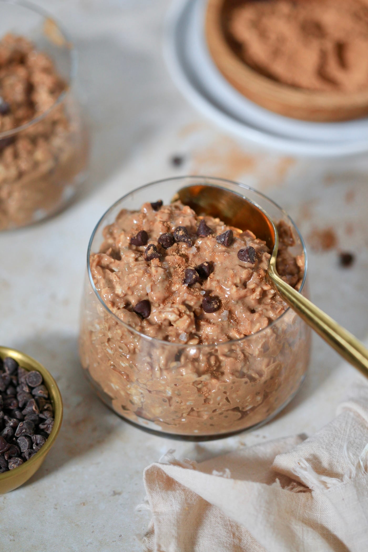 glass with chocolate oats and spoon.