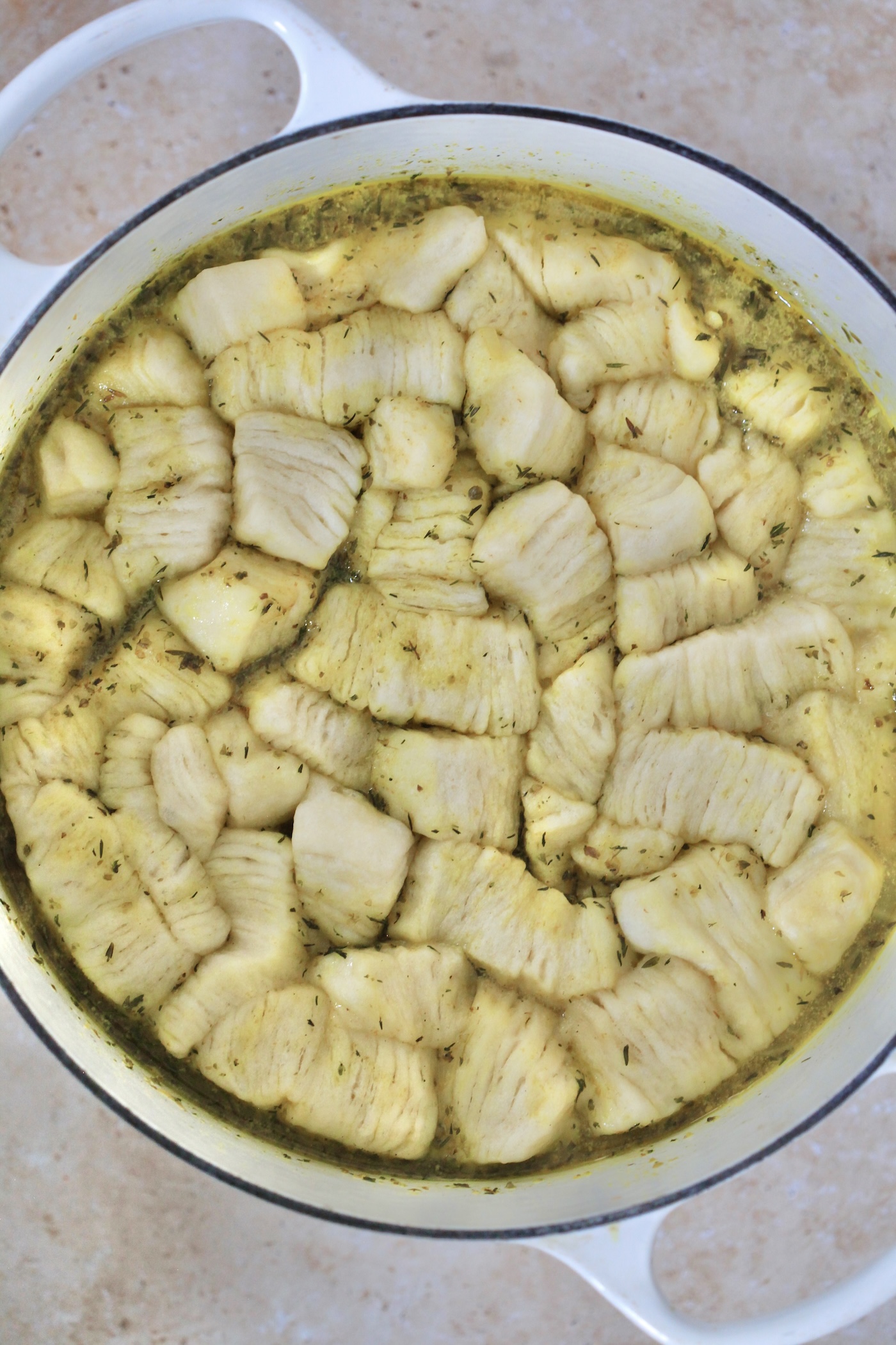 cooked biscuit dough on top of soup pot.