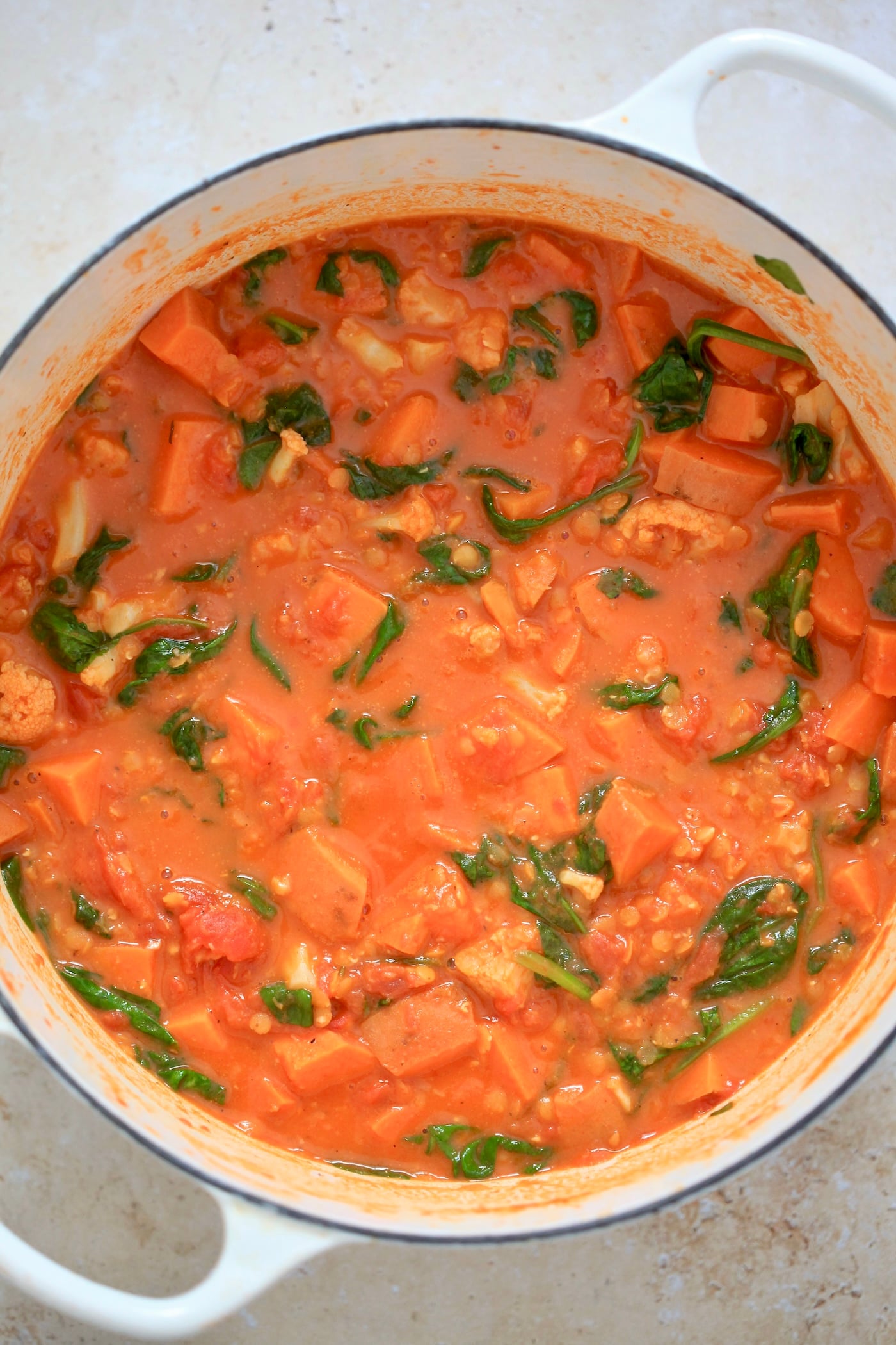 orange veggie mixture with spinach in pot