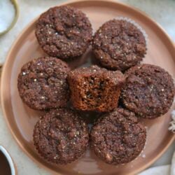 plate of gingerbread muffins with bite taken out.