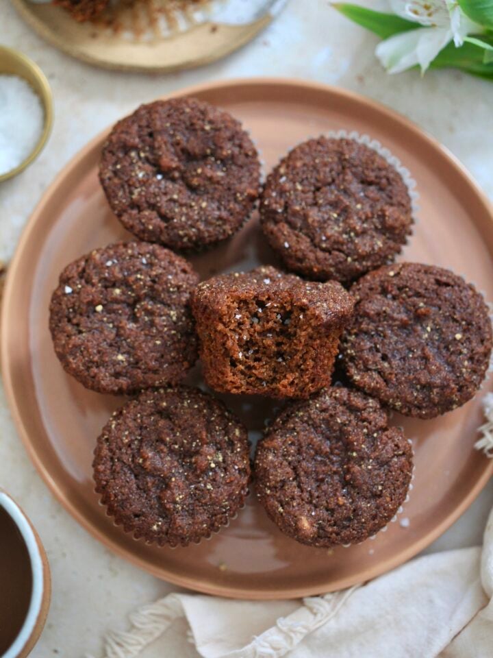 plate of gingerbread muffins with bite taken out.