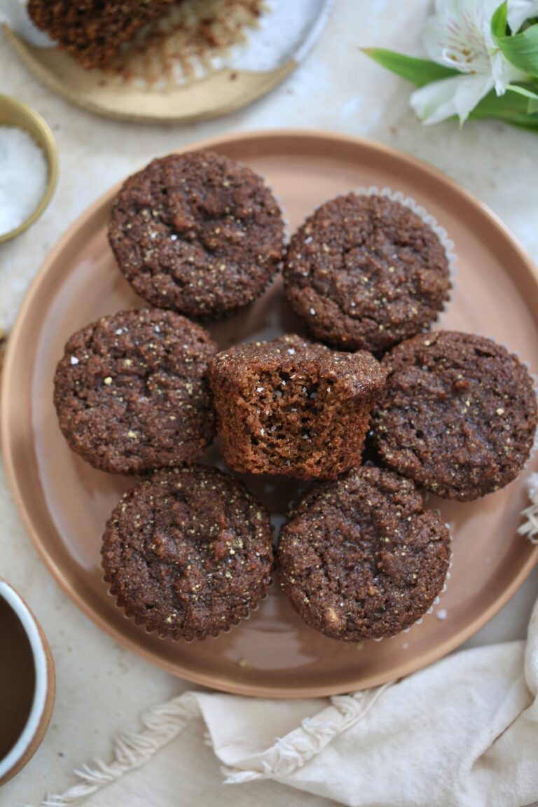 plate of gingerbread muffins with bite taken out.