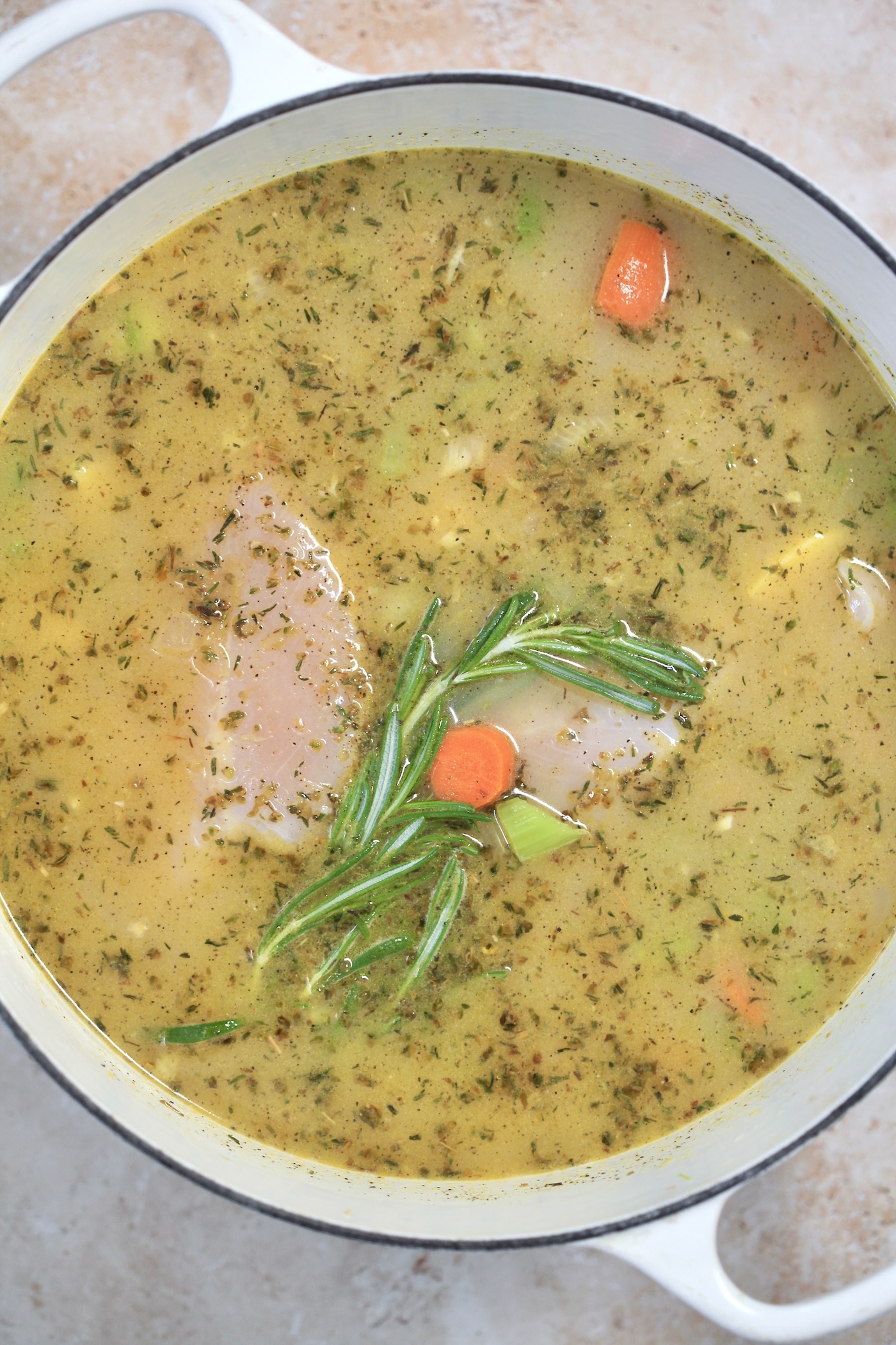 broth and chicken in pot.