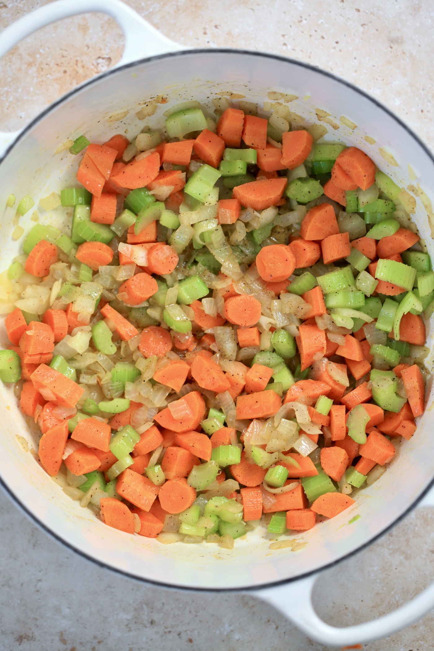 carrots, onion, and celery in pot.