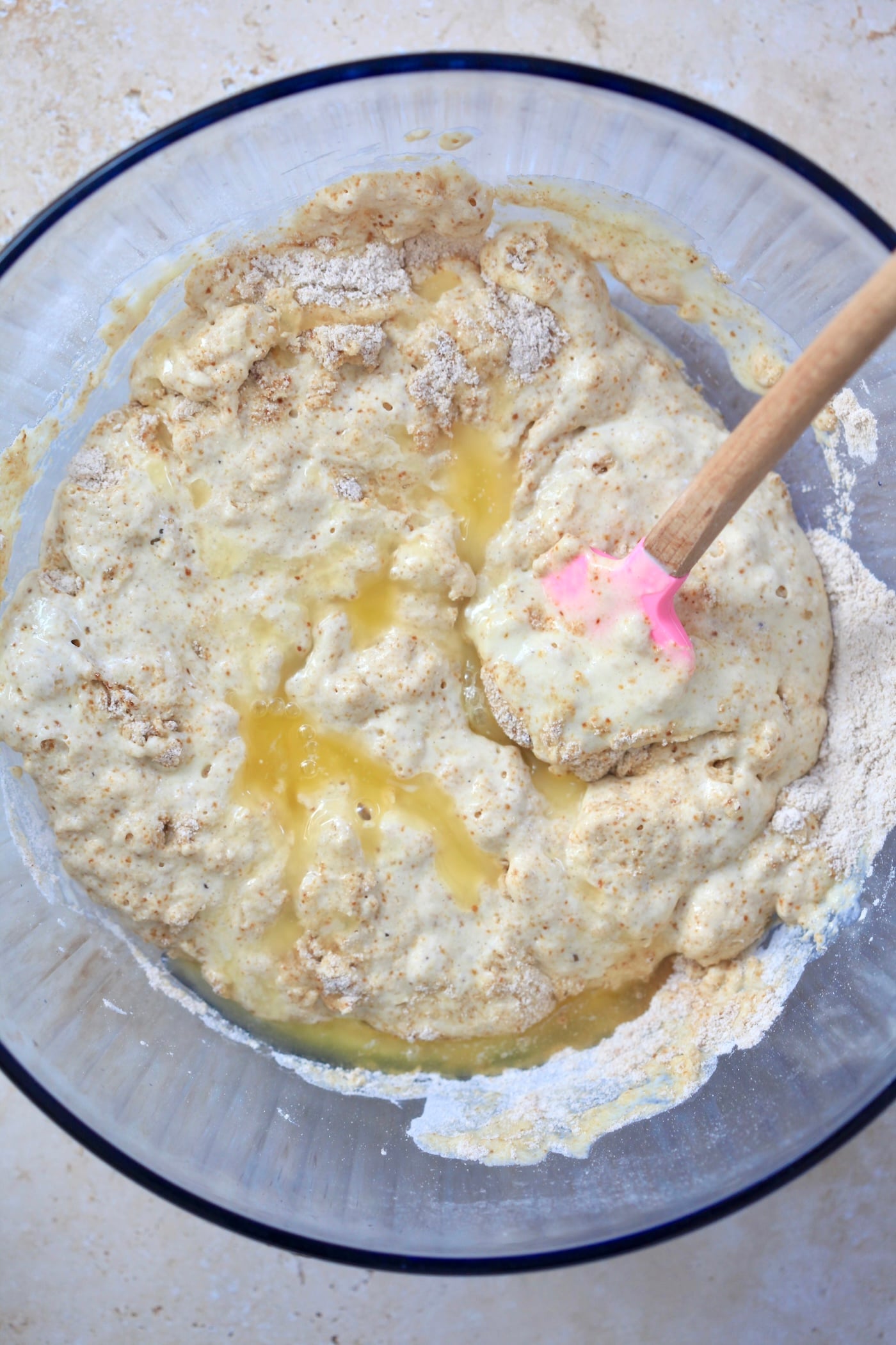 mixed batter in blue bowl with melted butter throughout.