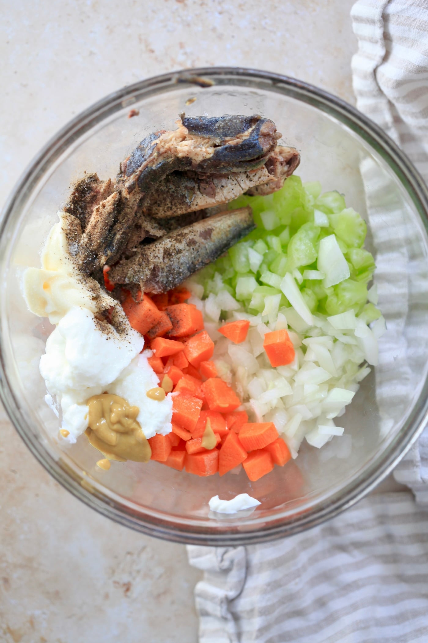 sardines, yogurt, and veggies in glass mixing bowl.
