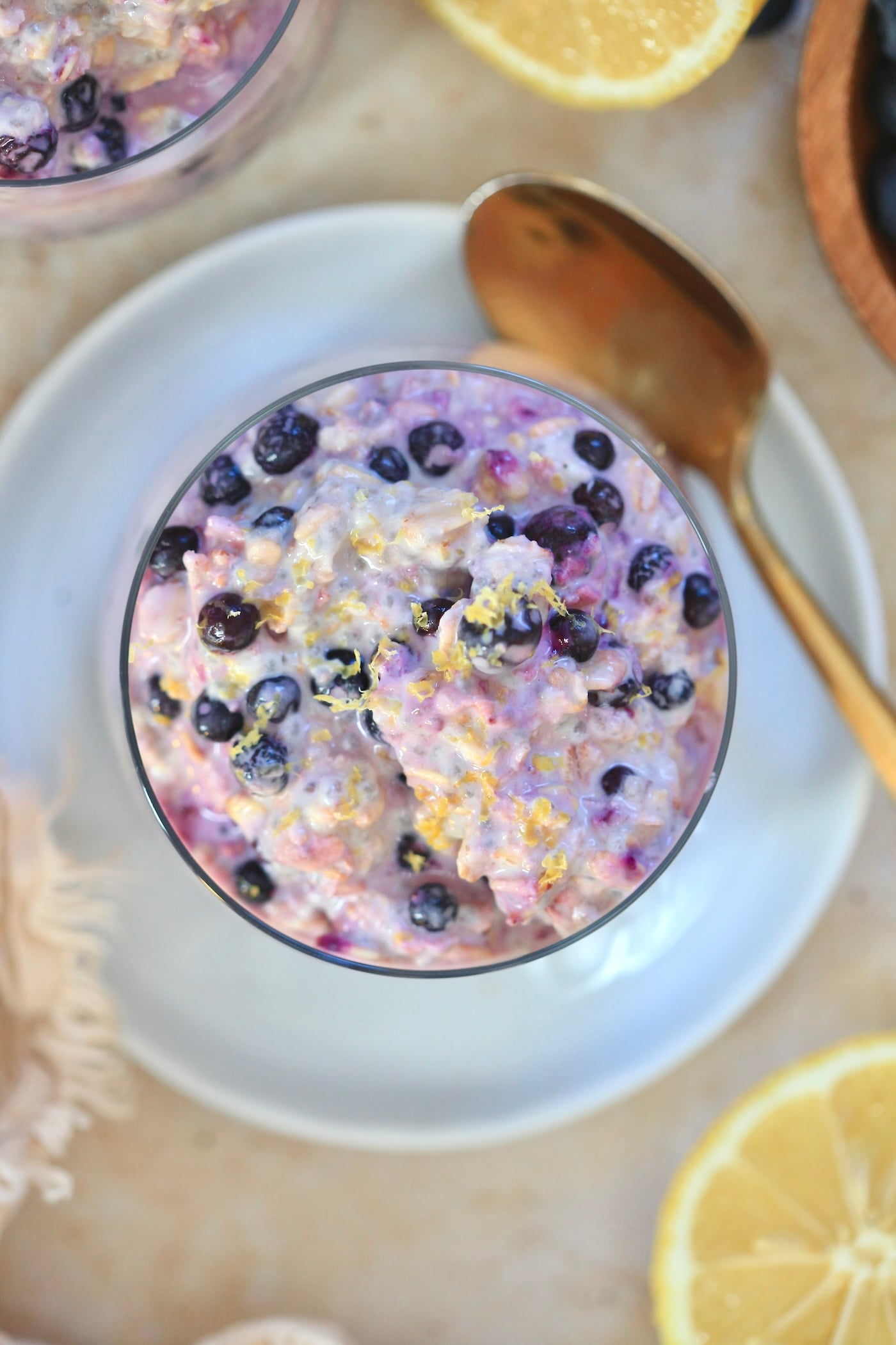 overhead views of blueberry oats with gold spoon.