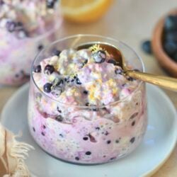 glass with blueberry oats and lemon in background.