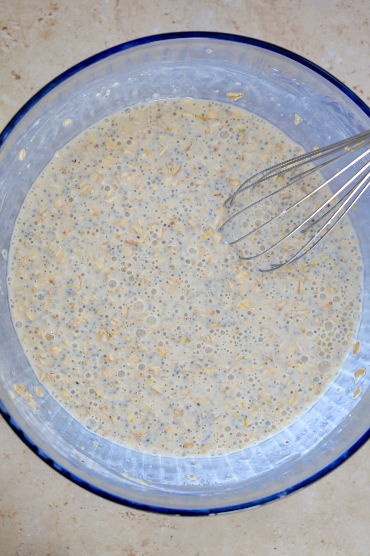 liquidy oats with whisk in mixing bowl.