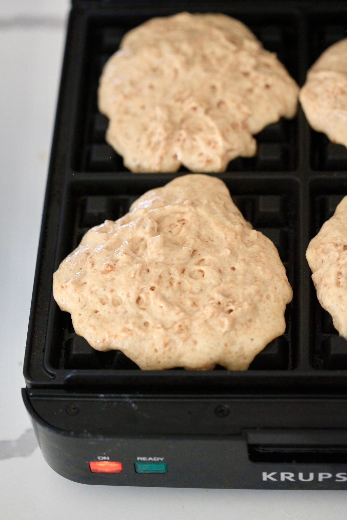 raw batter on waffle iron.