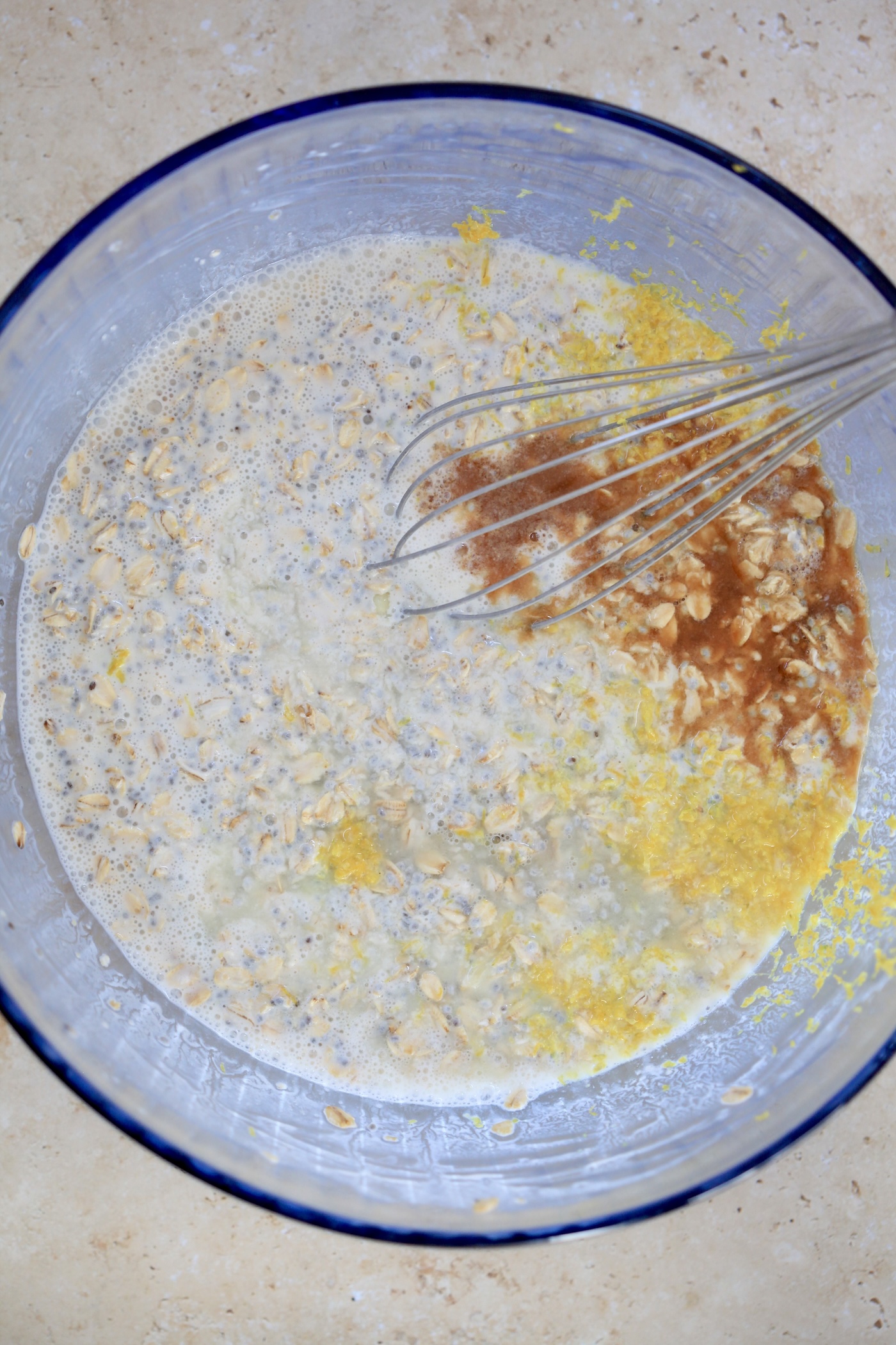 wet oat mixture in mixing bowl with lemon zest and vanilla.