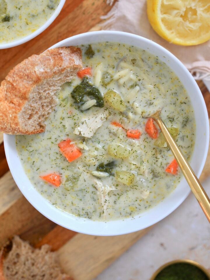 white bowl with creamy soup and lemon in background.