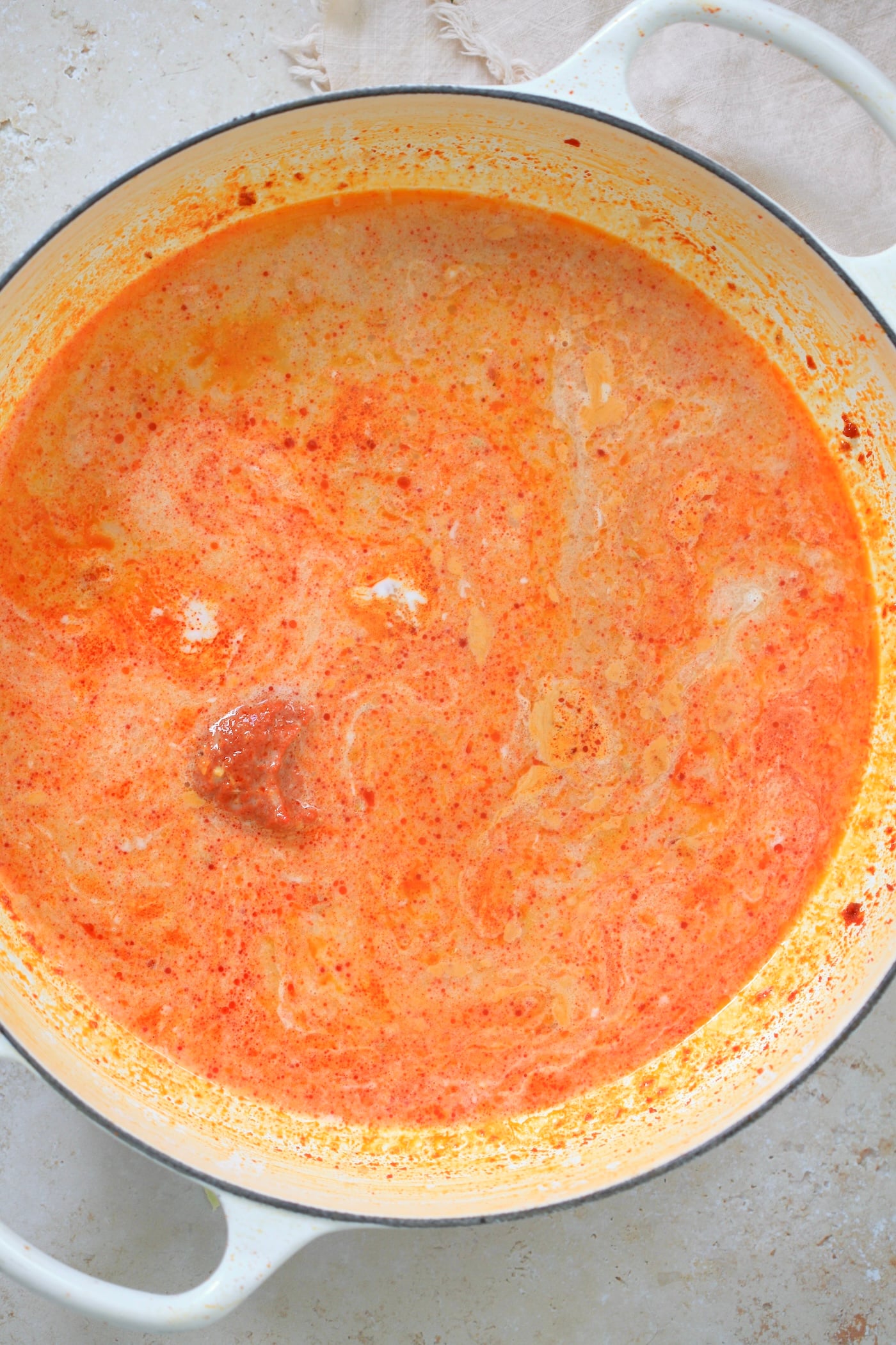 creamy white and orange mixture in shallow pan.