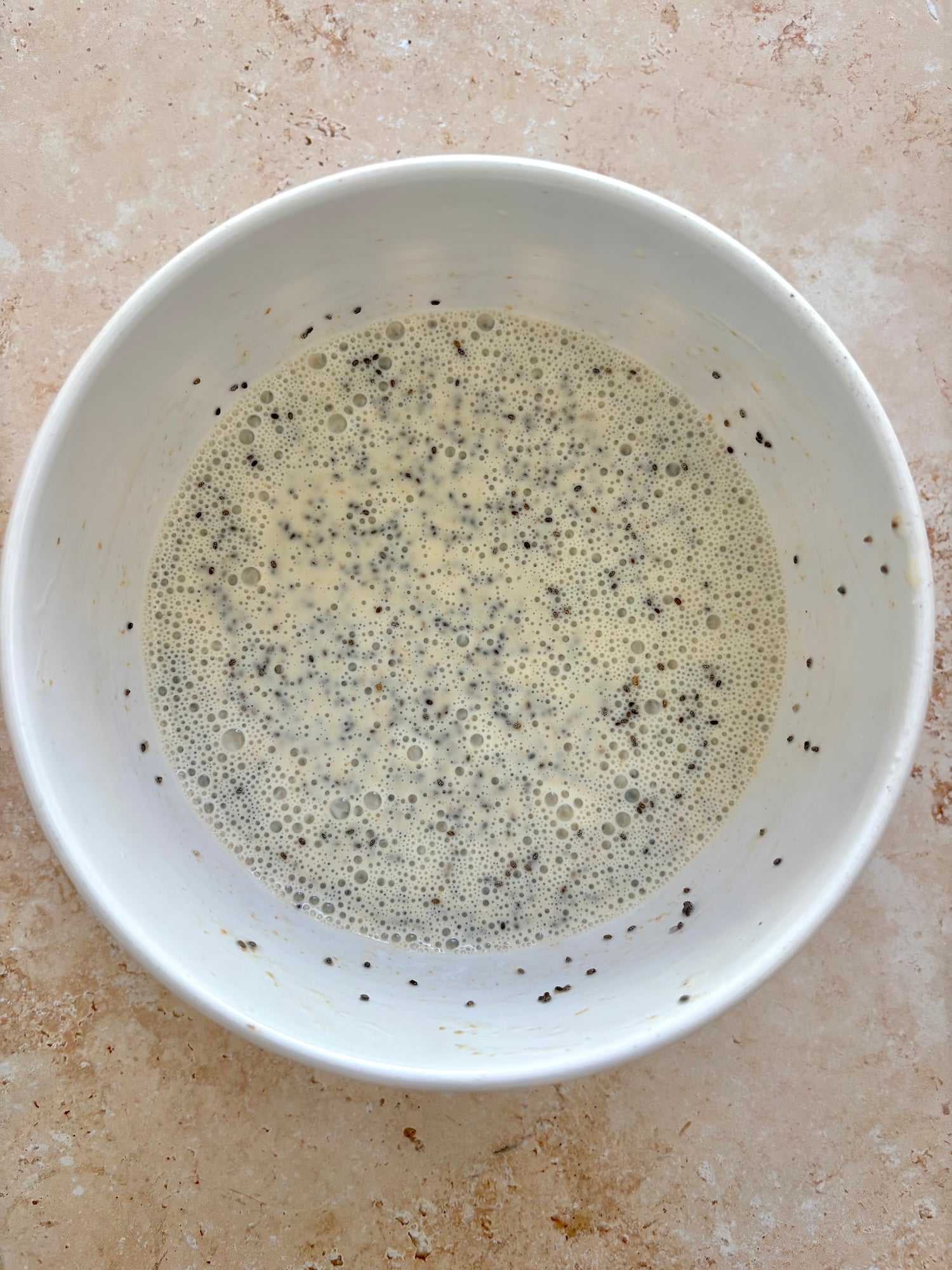 mixed black seeds in liquid.