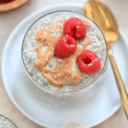 chia pudding in glass with raspberries.