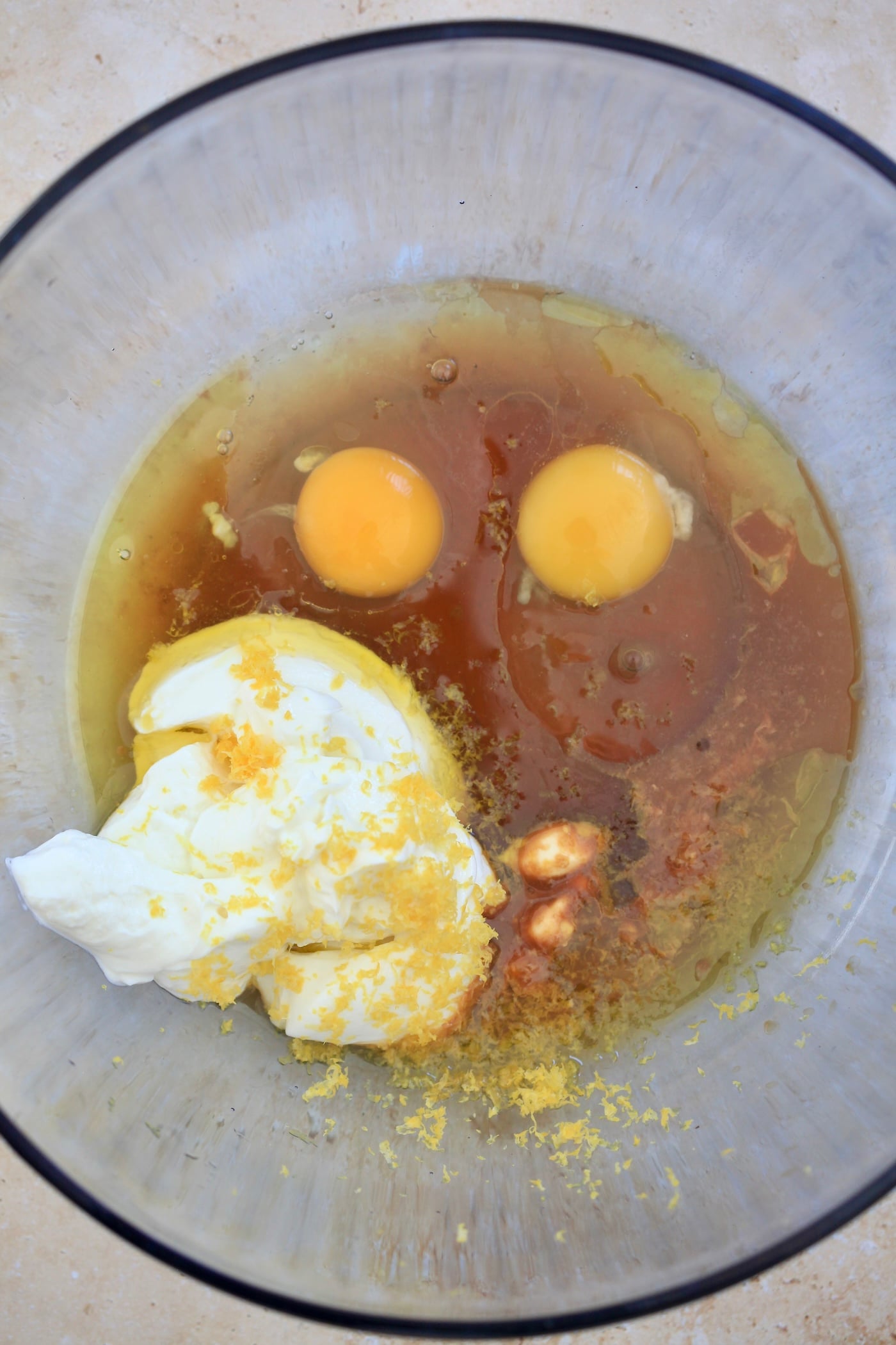 yogurt, maple syrup, and eggs in a blue bowl.