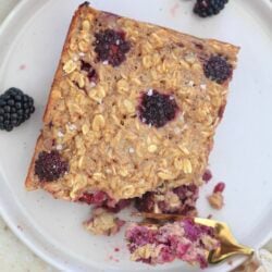 piece of oatmeal with blackberries and fork taking bite out