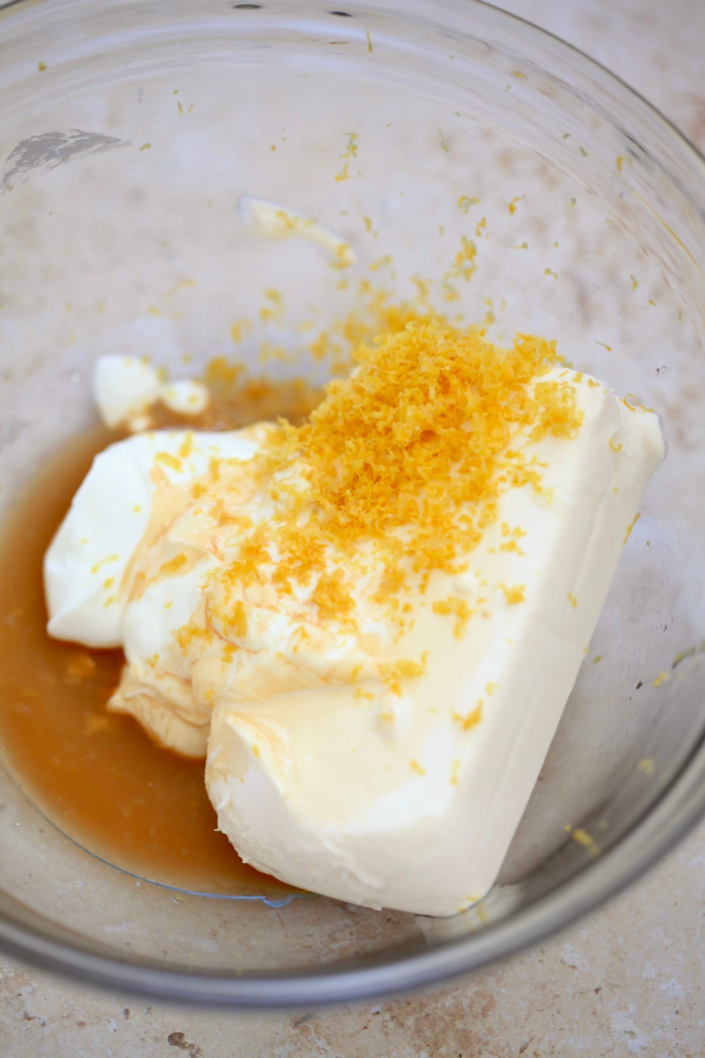 cream cheese and lemon zest in bowl.