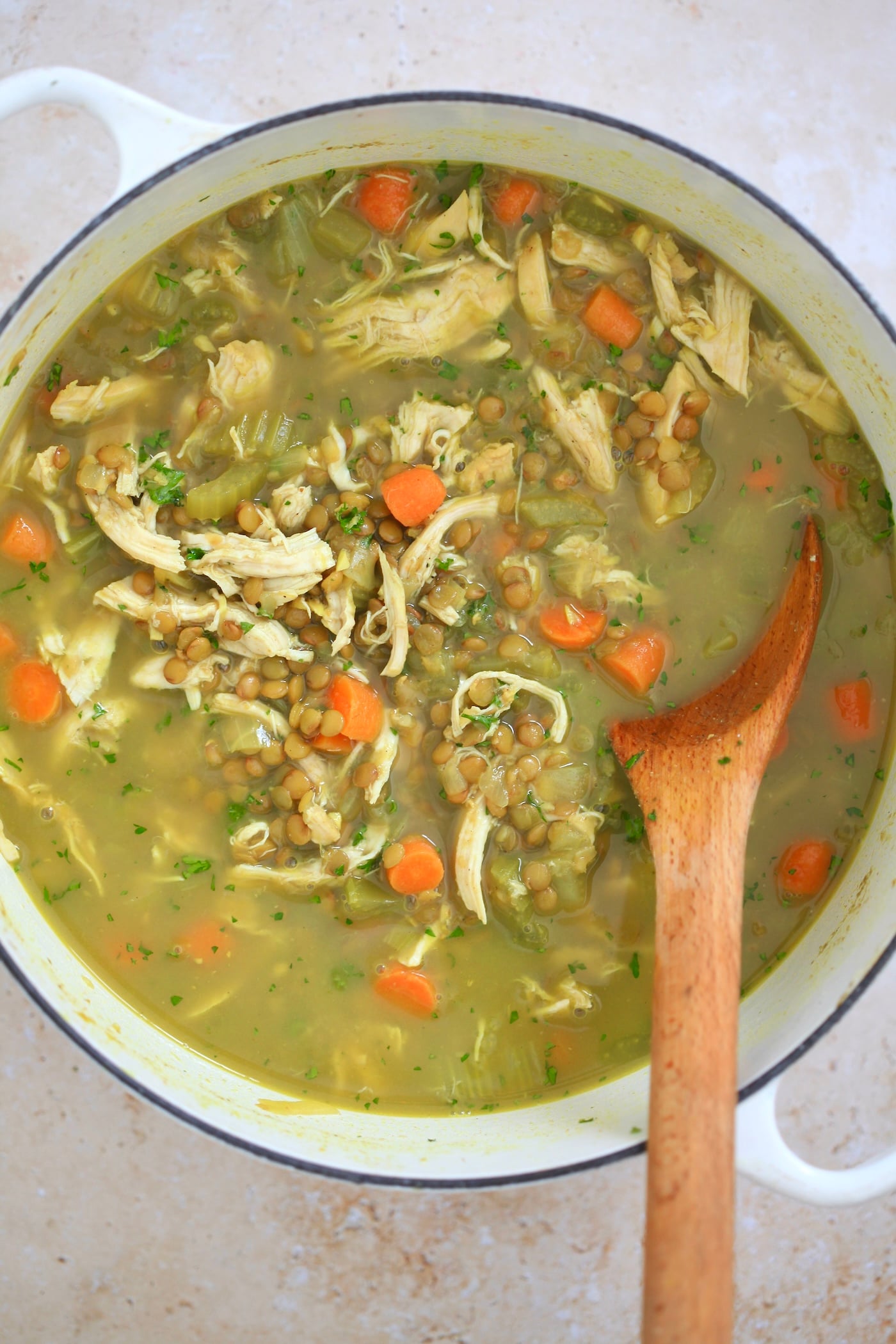pot of yellow chicken soup with veggies.