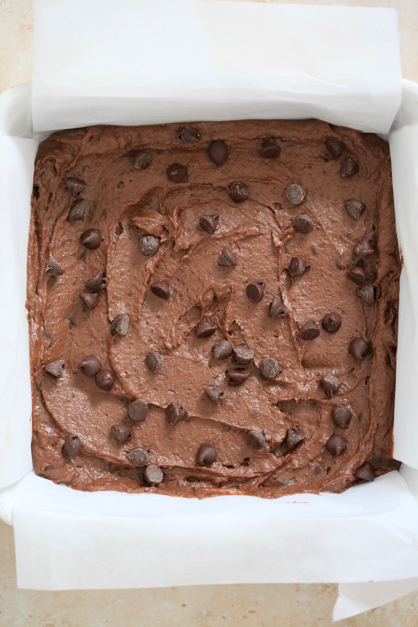 unbaked brownie batter in pan.