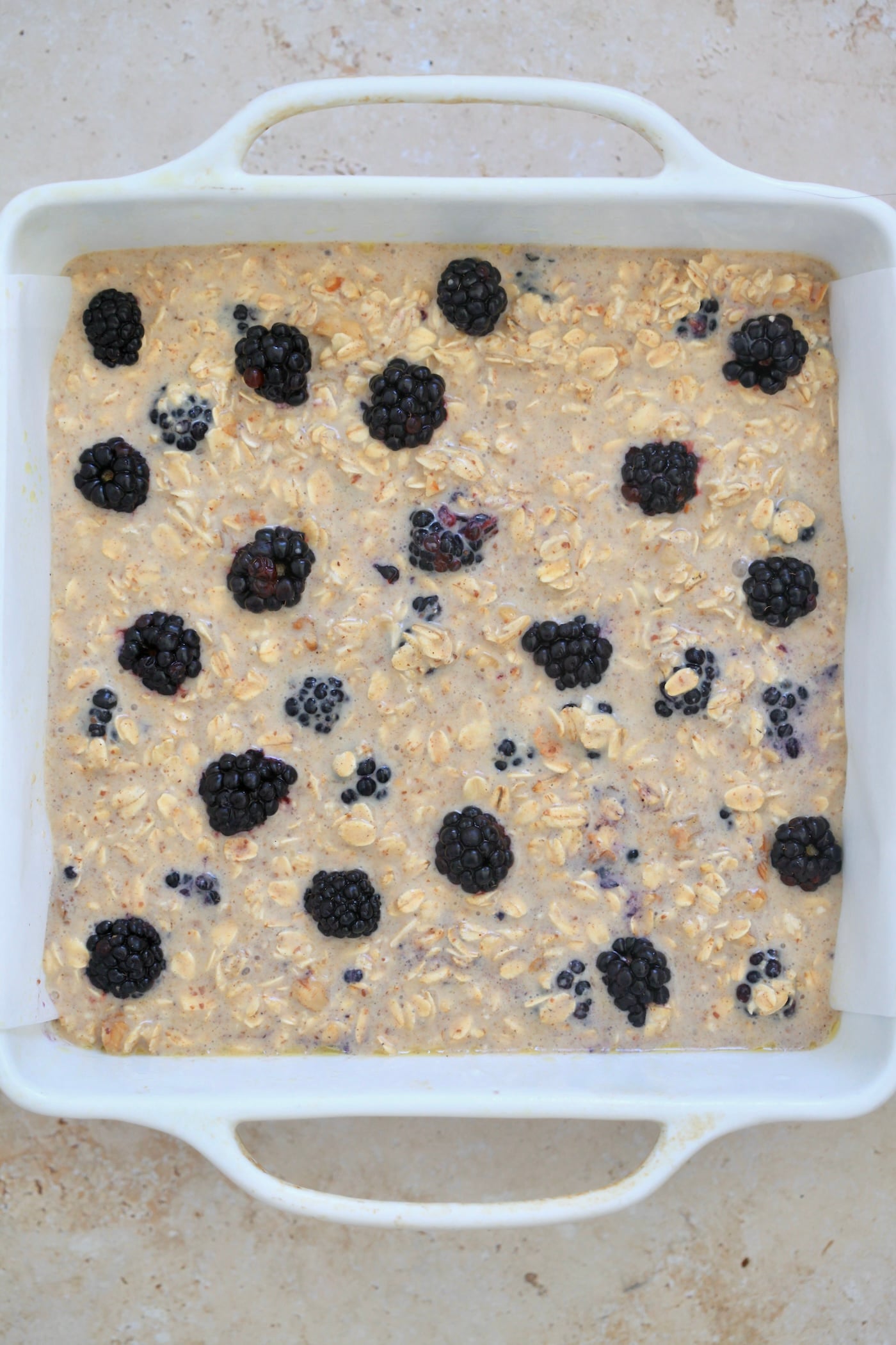 unbaked oatmeal with blackberries in pan.
