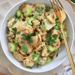 bowl with bean herby bean salad, lemon and gold fork