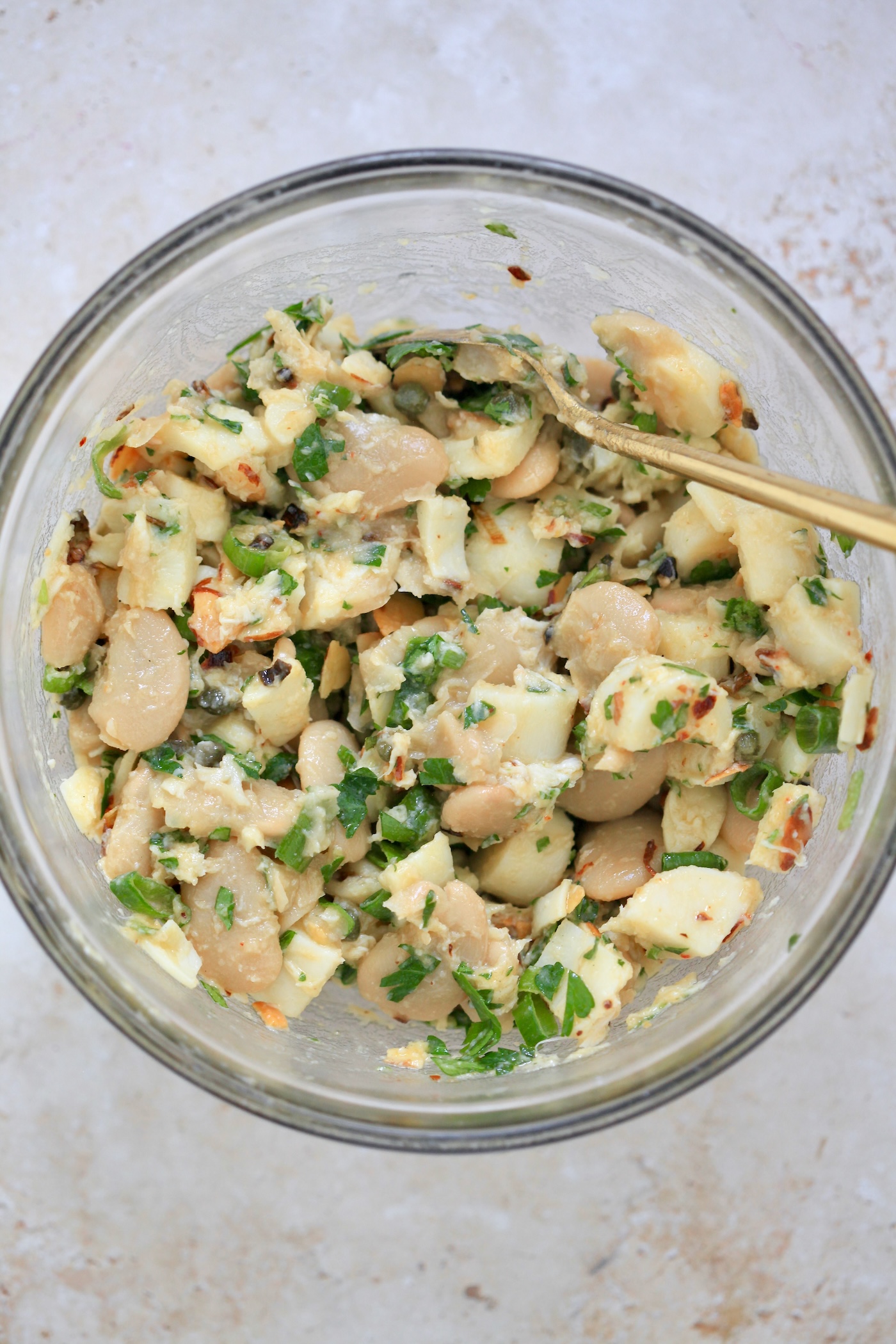 mixed creamy bean salad in bowl.