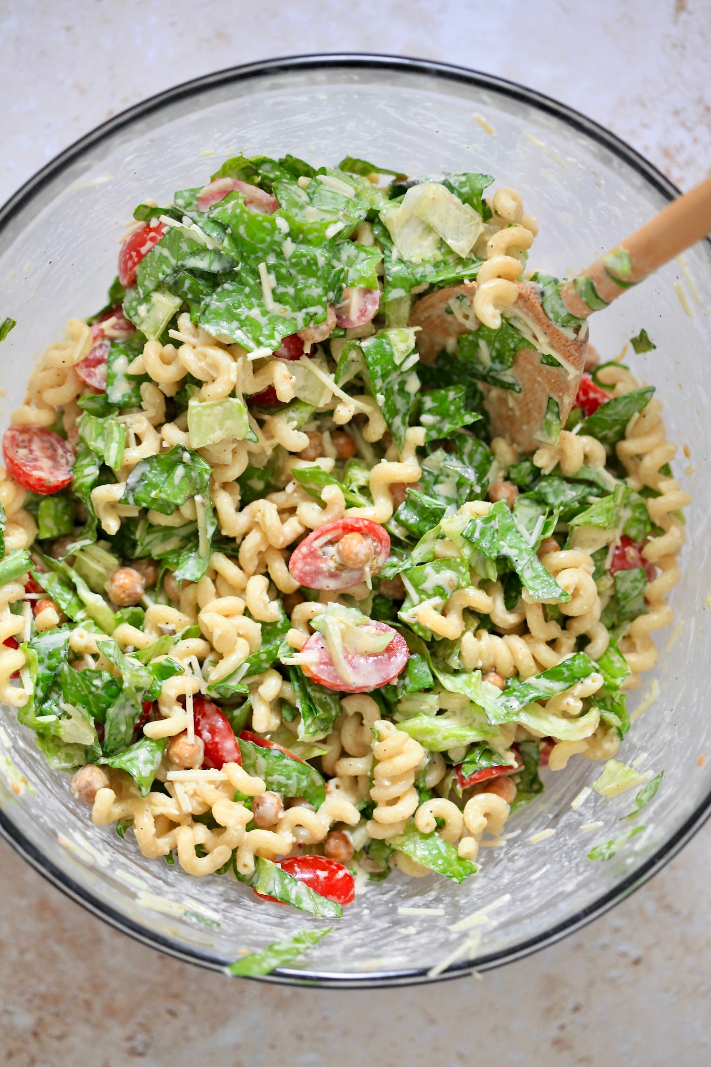 lettuce and pasta in a bowl with creamy dressing