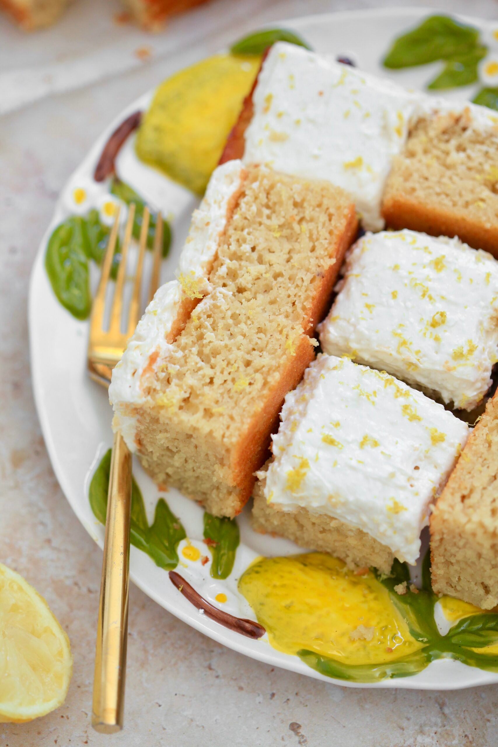 side close up view of squares of lemon cake on plate.