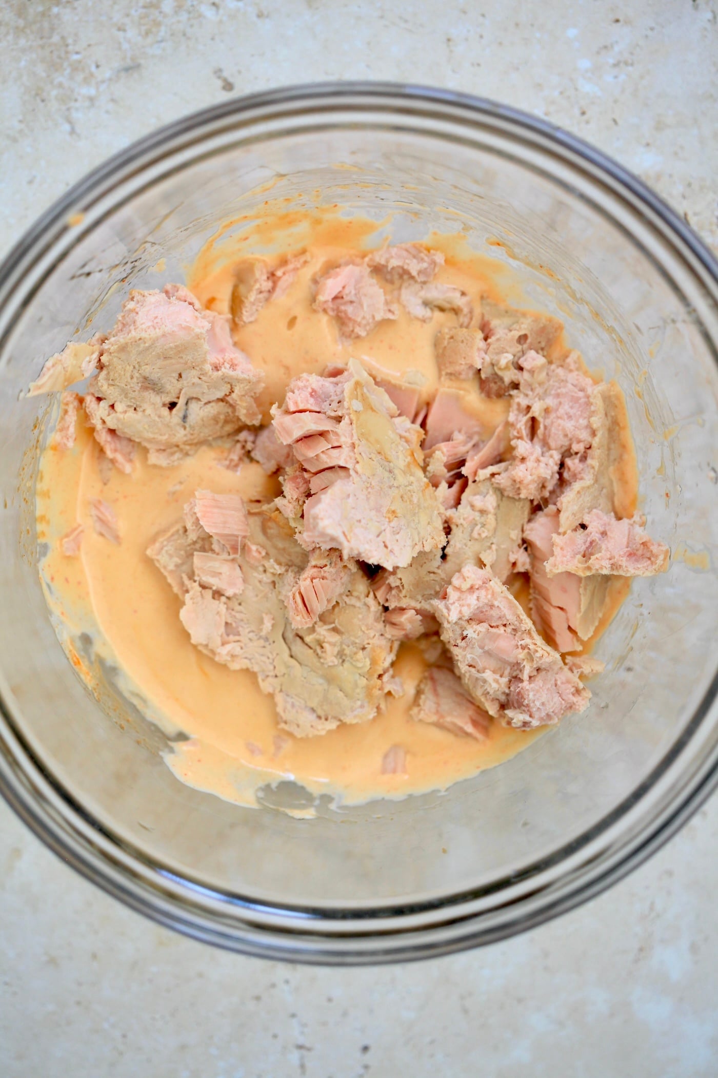 orange mixture in bowl with tuna on top.