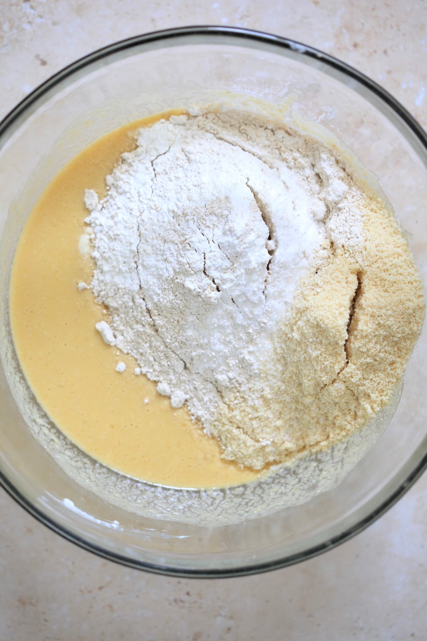mixed batter in bowl with flour on top.