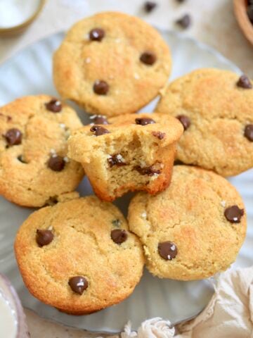 plate of chocolate chip muffins with bite taken out.