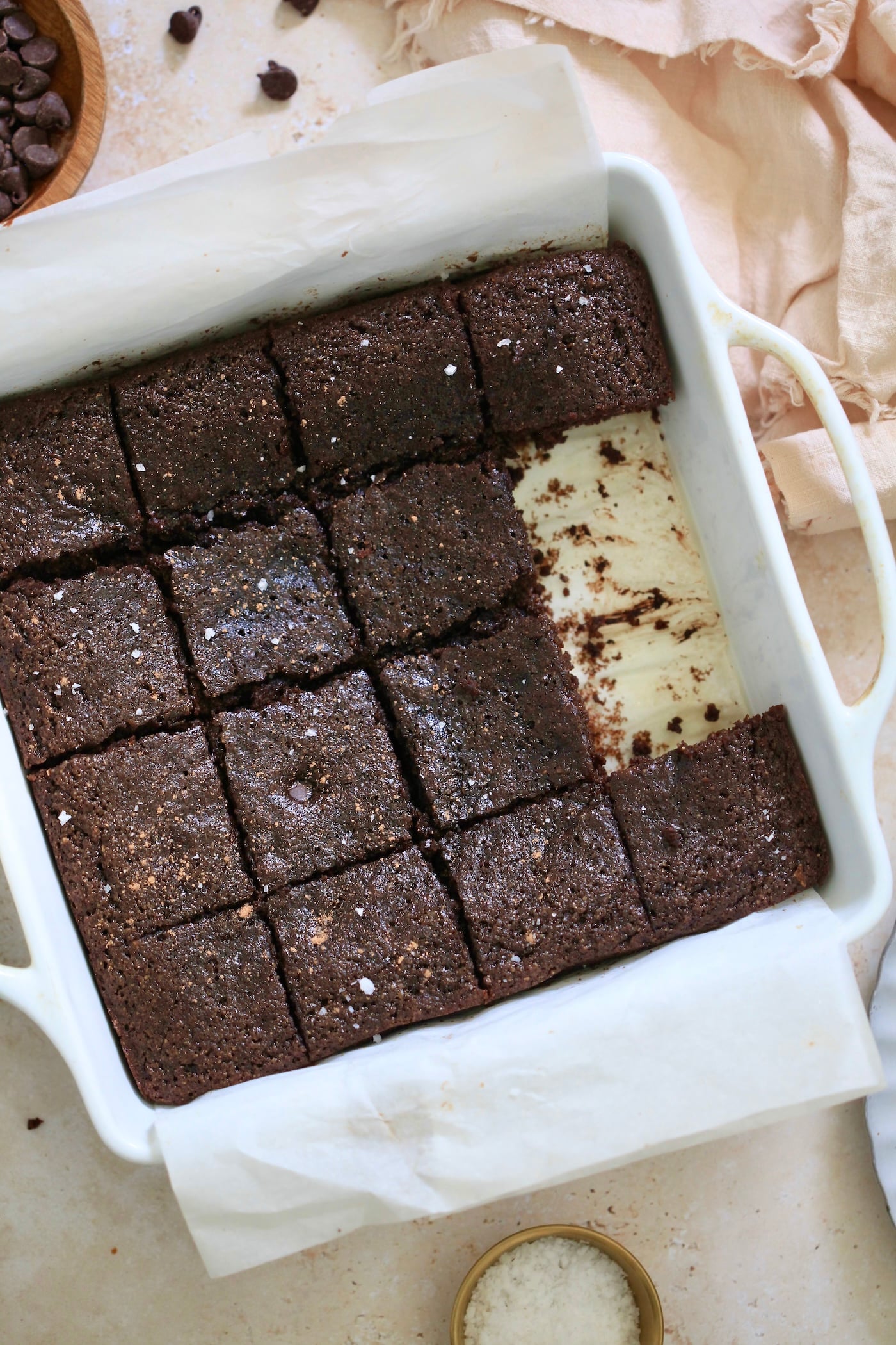 sliced chocolate cake in pan with pieces taken out.