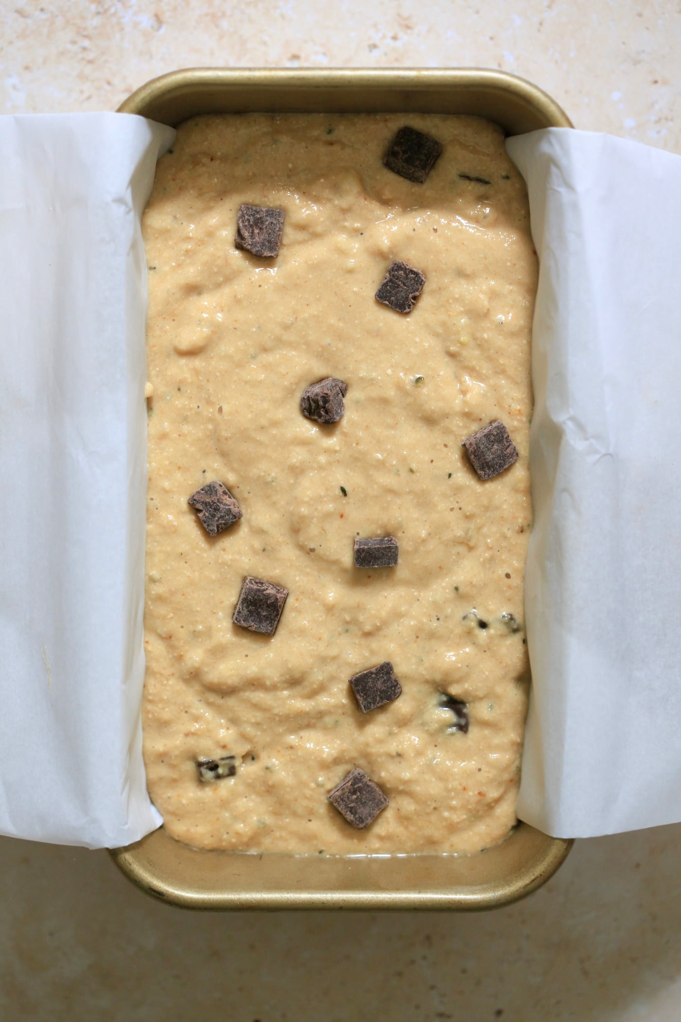 unbaked batter in lined loaf pan.