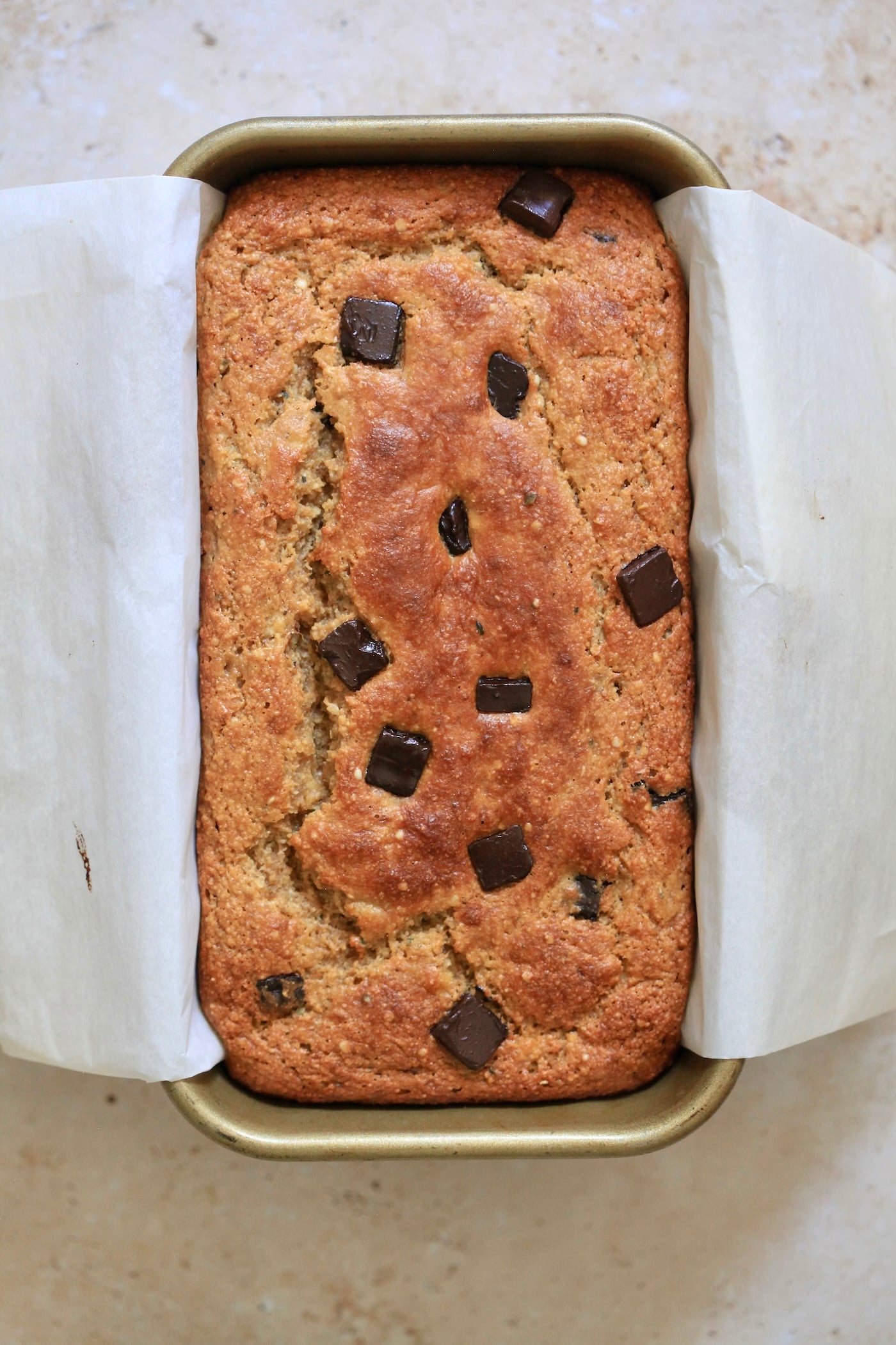golden brown baked bread in loaf pan.