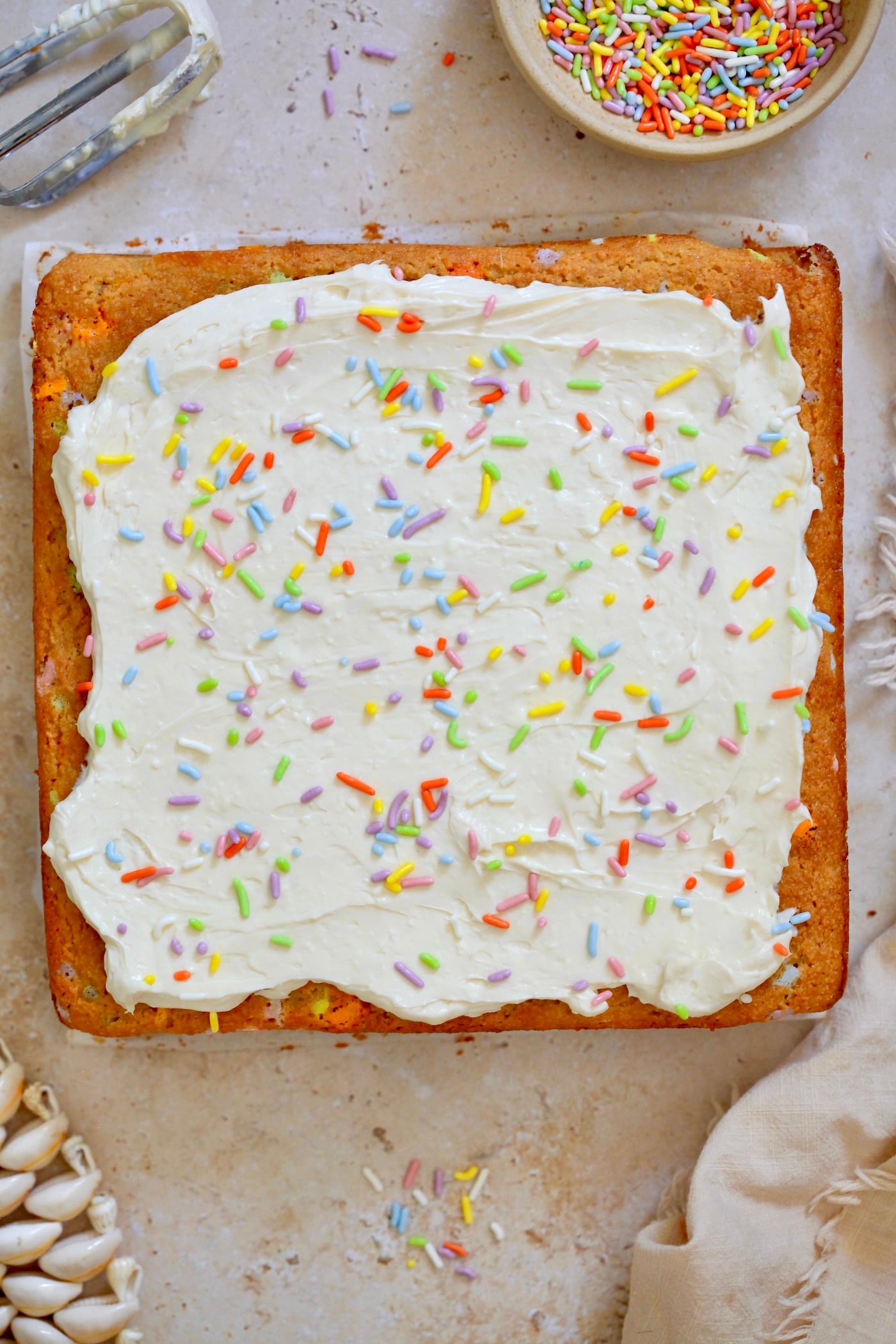 frosted square cake with sprinkles.