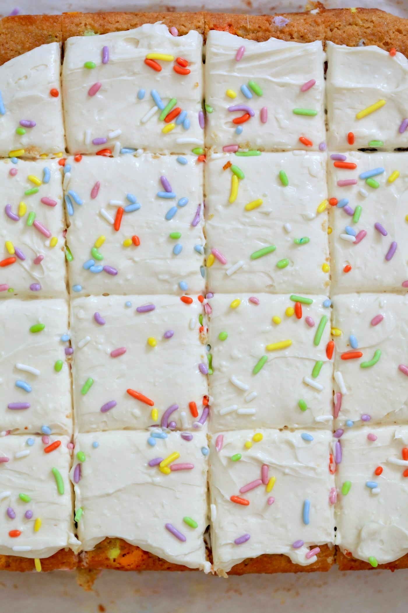 frosted sprinkle cake sliced.