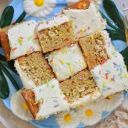frosted cake pieces on blue plate with rainbow sprinkles.