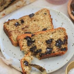 two slices chocolate chunk banana bread on plate with bite taken out.