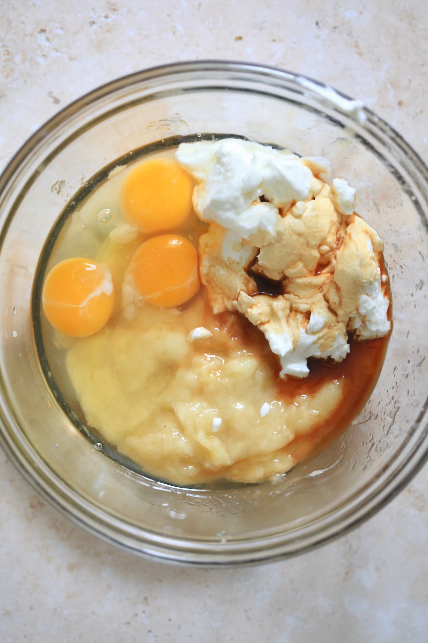 eggs, banana, yogurt, and vanilla in mixing bowl.